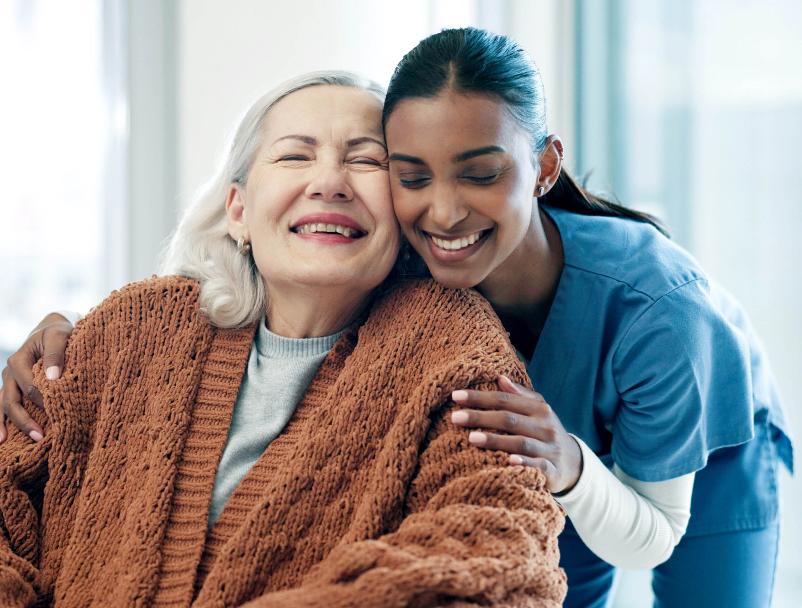trust, caregiver and hug with old woman in home for assisted living, smile and healthcare service. embrace, comfort and elderly person with nurse in house for medical support, happiness or retirement